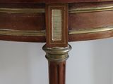 a wooden table with a brass plate on top of it