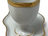 a cup and saucer on a saucer on a white surface