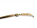 a close up of a gold bracelet with a snake on it