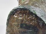 a close up of a statue of a dog with a name on it