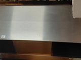 a cat that is sitting on a counter in a kitchen