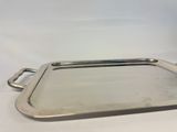 a silver tray with handles and handles on a white surface