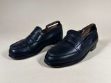 a pair of men ' s blue loafers on a white background