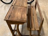 a bicycle that is parked next to a table and bench