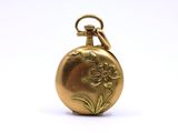 an image of a gold pocket watch with a flower on it