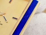 a close up of a wrist watch with a blue band