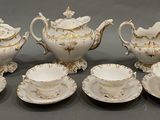 an image of a group of white and gold tea and coffee cups and saucers