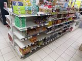 a lot of shelves in a store that have various items on them