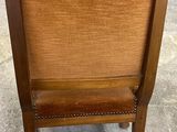 an image of a wooden chair sitting on top of a cement floor