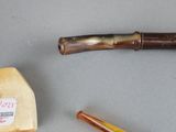a pipe and a piece of wood next to a piece of wood
