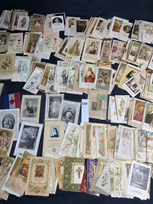 a lot of old postcards on a black table