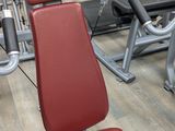 a gym room with a row of machines and other equipment