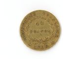 an old coin with the number 40 on it on a white surface