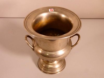 a silver vase that is sitting on a table
