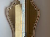 a mirror on the wall above a sink in a bathroom
