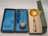 three silver spoons and a spoon in a box