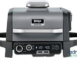 an image of a grill with a timer on the side of it