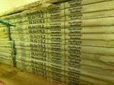 newspapers stacked on top of each other on a shelf in a room