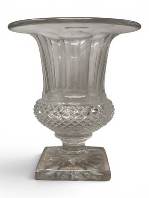 a glass vase that is sitting on a stand