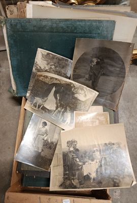 a box full of old photos sitting on the floor