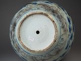 a blue and white vase with a hole in the middle