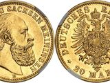 a gold coin with the image of a man and eagle on it