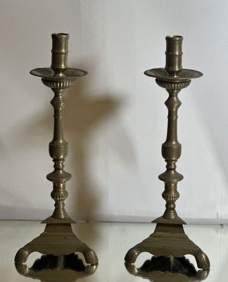 two candles that are sitting on a glass table