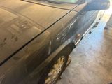 a dirty car that is parked in a garage