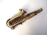 a saxophone that is laying on a white surface
