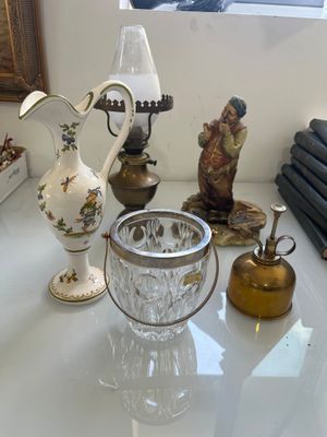 a white table with a vase and a lamp on top of it