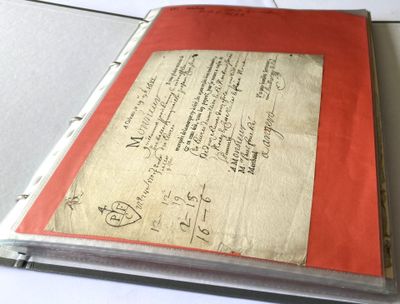 a red book with writing on it sitting on a table