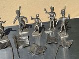 five figurines of soldiers with flags on a table