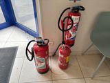 two fire extinguisors sitting next to each other on the floor