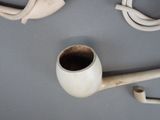 a pipe and a pipe holder on a table