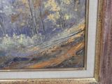 an oil painting of a landscape with trees in a gold frame