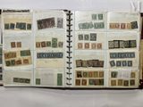an open book with lots of stamps on it sitting on top of a table