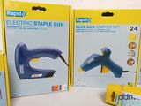 two boxes of electric stapler and glue gun sitting on a table