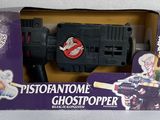 a box with a toy gun in it on a table