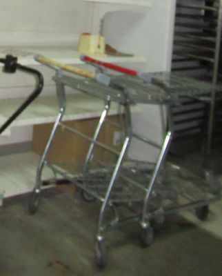 a metal cart with a glass top in a kitchen