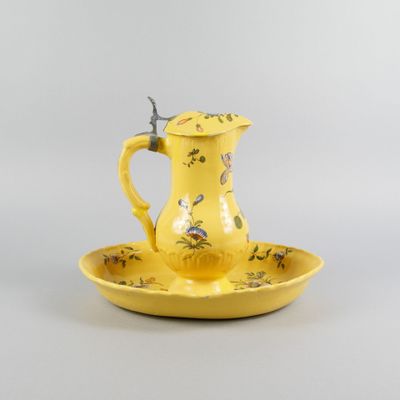 une assiette jaune sur laquelle est posé un pichet jaune
