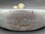 a stone bowl with two eggs on top of it