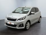 the small silver car is parked in a room with a black floor