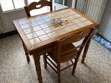 a table and chairs in a room with a tile floor