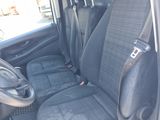 the interior of a car with black seats and a steering wheel