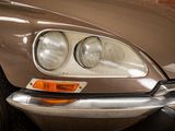 a close up of a car ' s headlight and the front end of the car