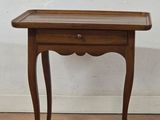 an image of a small wooden table with a drawer on it