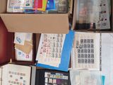 a box full of stamps and other items on the floor