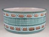 a blue bowl with brown designs on it