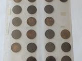 several different types of coins are displayed in a display case