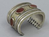 silver cuff bracelet with red stones and gold accents